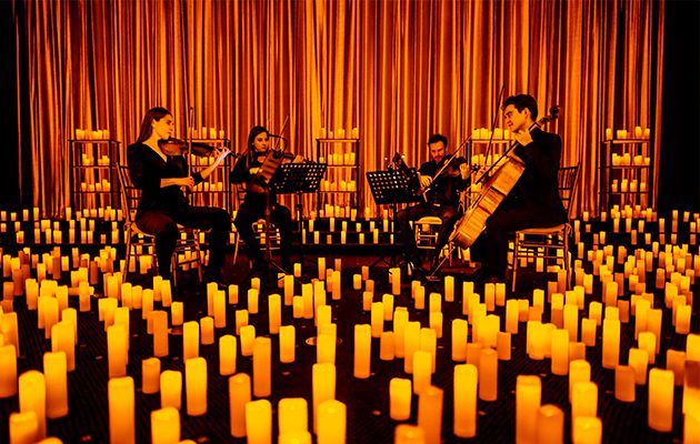 A string quartet performing among hundreds of candles at a Candlelight concert in Miami